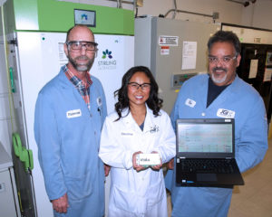 The JGI Freezer Challenge Team (left to right): Tom Vess, Christine Naca and Don Miller in front of two freezers being monitored by the Klatu system. As part of JGI's efforts to become more sustainable, Stirling freezers like the one on the left are being phased in because they use less than half of the energy consumed by the older freezer on the right.