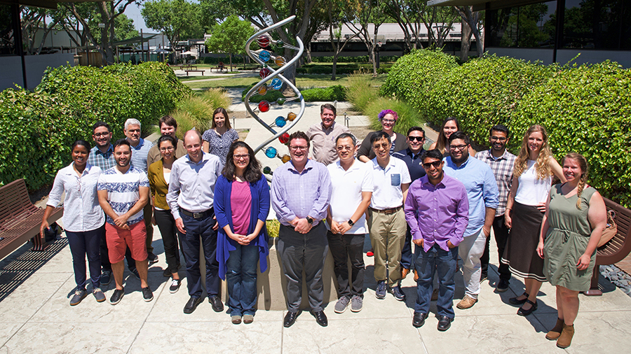 Directly in front of the helix, JGI Director Nigel Mouncey and JGI-UC Merced Genomics Internship founders organizers Axel Visel, Suzanne Sindi and Zhong Wang are flanked by UC Merced student alumni and their JGI mentors. 