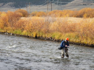 Grad student Brian Wolff samples the Arkansas River.