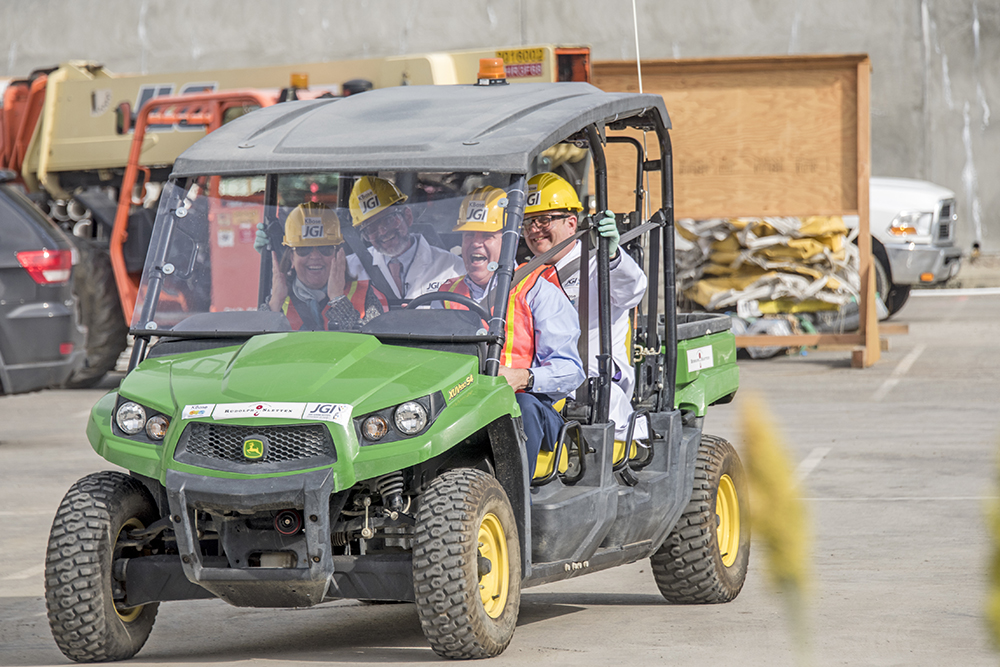 Ray Turner drives JGI Director Nigel Mouncey (behind the driver's seat) and KBase PI Adam Arkin (back seat passenger) to the stage of the Integrative Genomics Building Groundbreaking Event at Berkeley Lab.